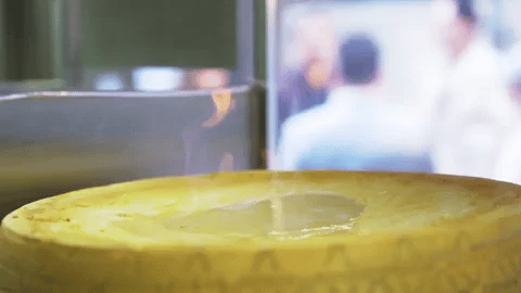 Parmesan wheel tableside flambé fine dining luxury Italian chef spectacle - Premium Italian culinary theater by Vitalitaly