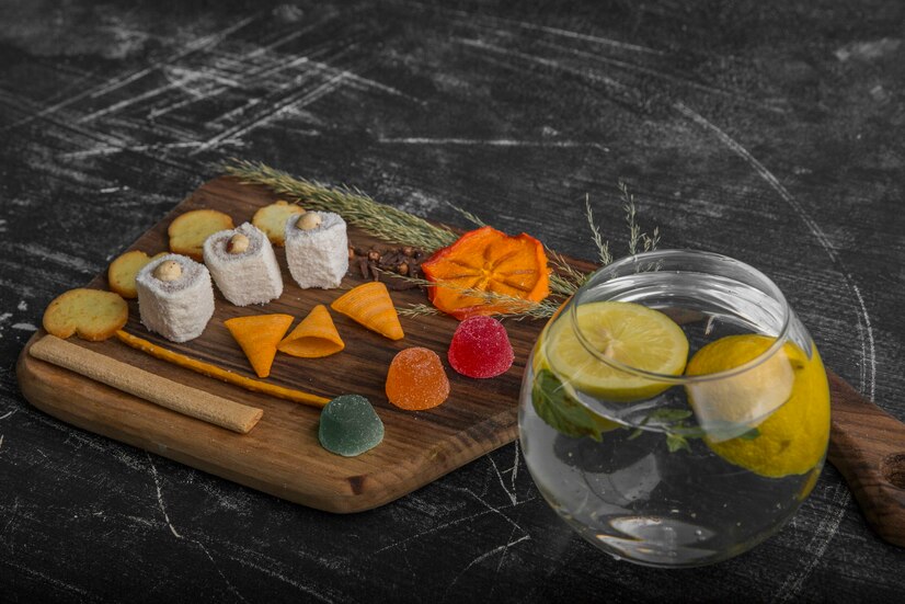 Gin & Tonic Balsamic Vinegar drizzled over a gourmet snack board with pastry and potatoes — Vitalitaly