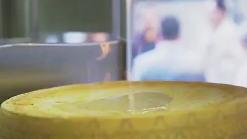 Load video: Authentic Italian gourmet food — flambéed Parmesan wheel with spaghetti, handcrafted by Vitalitaly, premium Italian products delivered across Europe