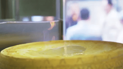 Vitalitaly Spaghetti tossed tableside in a flambéed Parmesan wheel — Fine dining Italian culinary theatre with bronze-drawn artisan pasta